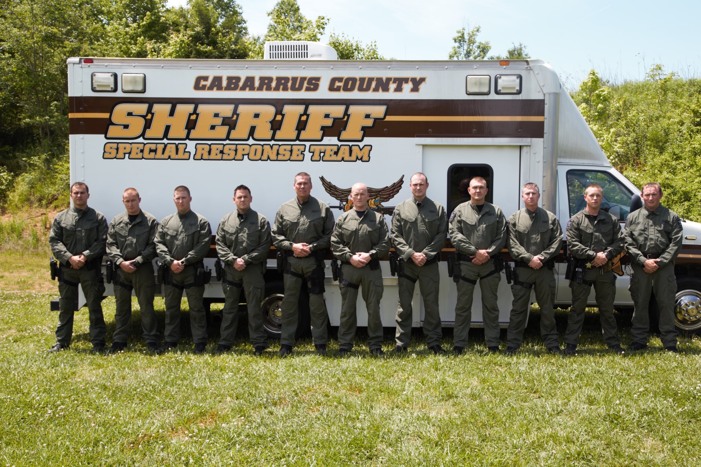 Picture of the team standing in front of the Cabarrus County Sheriff Special Response Team truck
