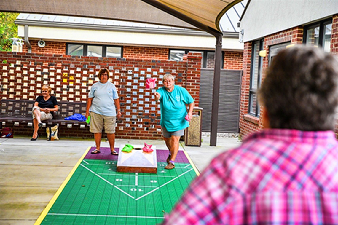 Senior Center Visitors Playing Corn Hole