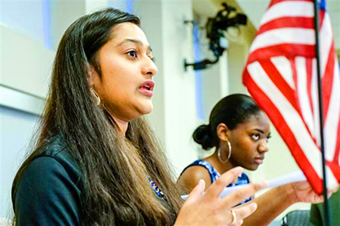 Young Woman Speaking at a Council Meeting