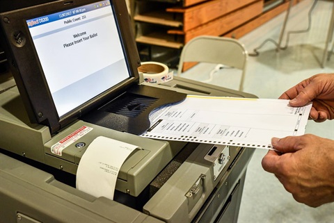 2017 election feeding ballot into voting machine